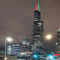 a signpost for Frank Reed Horton Way with the Chicago skyline in the background, as seen from the corner of Harrison and Halsted streets on December 16, 2019.